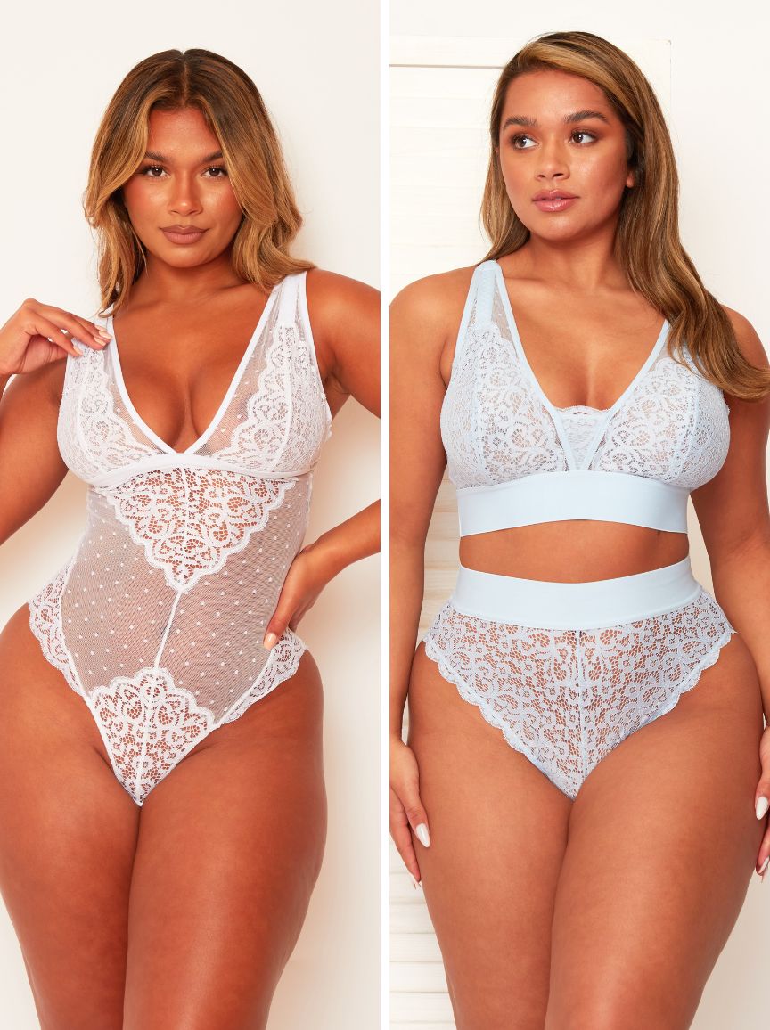 Two women modeling lace lingerie against a plain background
