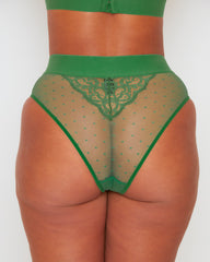 Close-up back view of the Abigail brief in Amazon Green, showcasing sheer polka-dot mesh with a lace panel at the centre back, a wide waistband, and a high-leg silhouette.