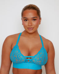 Close-up of the Amber Fuller Bust Bra in Bluebird Blue, featuring soft floral lace cups, decorative front strap detailing, adjustable shoulder straps, and a supportive underband designed for fuller busts.