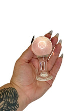 Hand holding a small glass Butt Plug