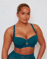 Close-up view of the Daley Lace T-Shirt Bra in Blue Coral, highlighting the smooth moulded cups, feminine floral lace accents, and centre-front keyhole detail for a refined finish.