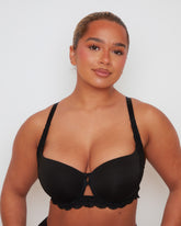 Close-up view of the Daley T-Shirt Bra in Midnight Black, showcasing the smooth cup finish, delicate lace trim, and signature centre-front keyhole detail.