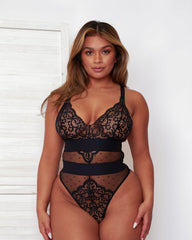 Front view of the Isabella Bodysuit in Midnight Black, featuring soft floral lace cups, sheer Swiss-dot mesh panels, and wide contouring waistband details for an elegant, hourglass silhouette.