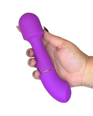 Purple toy held in a hand against a white background