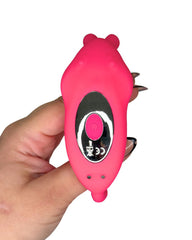 Pink device with a black screen held by a hand on a white background