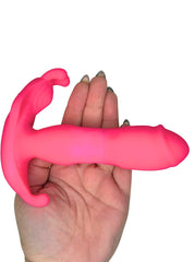Hand holding a pink silicone product against a white background