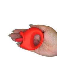 Red silicone ring held in a hand on a white background