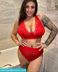 Customer wearing the Hallie Bralette and Brief Set in Chilli Pepper Red from Tutti Rouge, posing indoors. The set features floral lace fabric, sheer mesh details, and matching high-waisted briefs.
