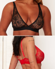 Black lace bra and red lingerie set on a neutral background