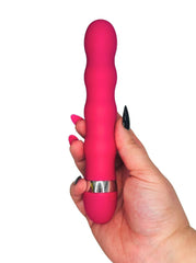 Pink vibrator held by a hand on a white background