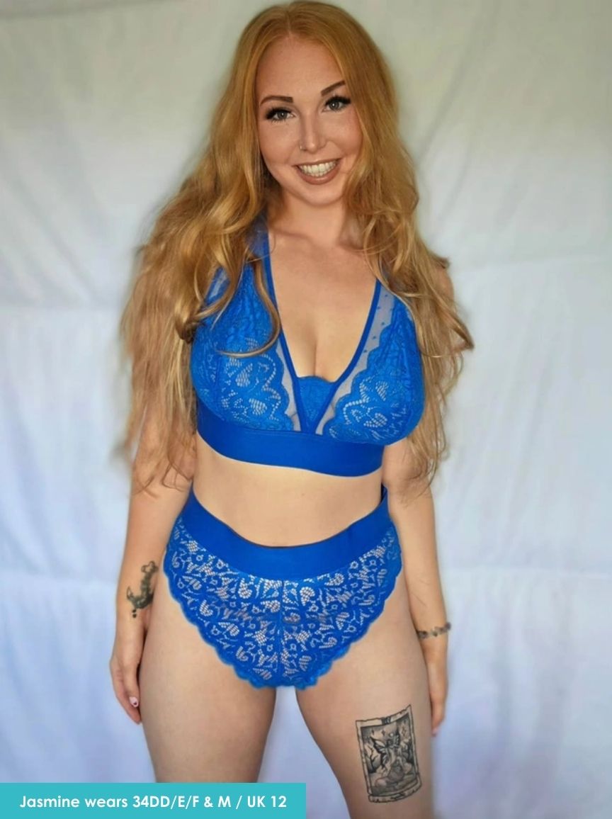 Woman wearing a blue lace lingerie set against a plain background