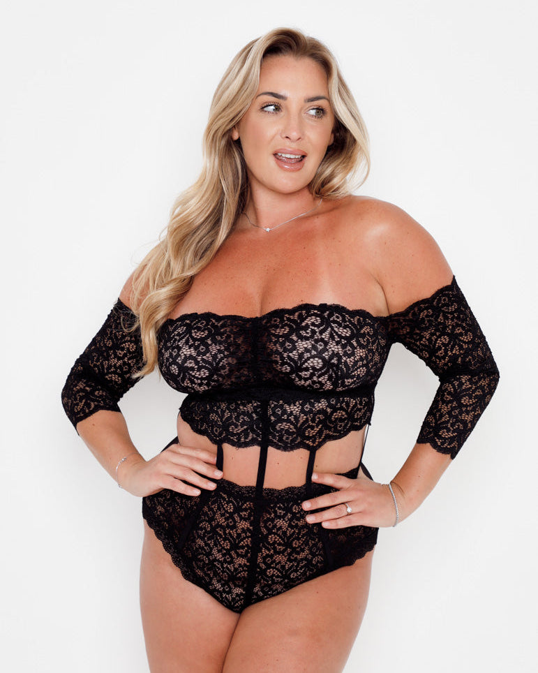 Alix Bodysuit in Midnight Black featuring delicate floral lace, off-the-shoulder sleeves, sheer mesh panels and corset-inspired detailing for a flattering, statement lingerie look.
