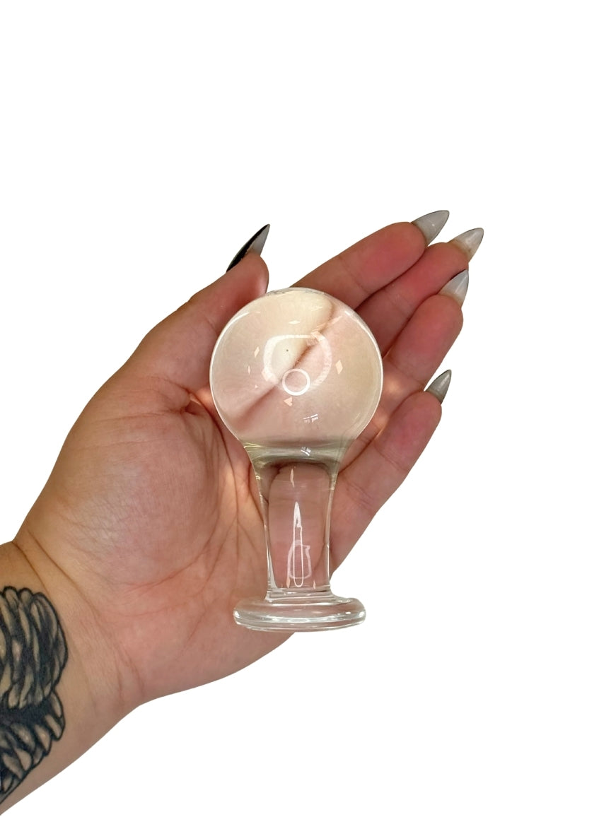 Hand holding a small glass Butt Plug 
