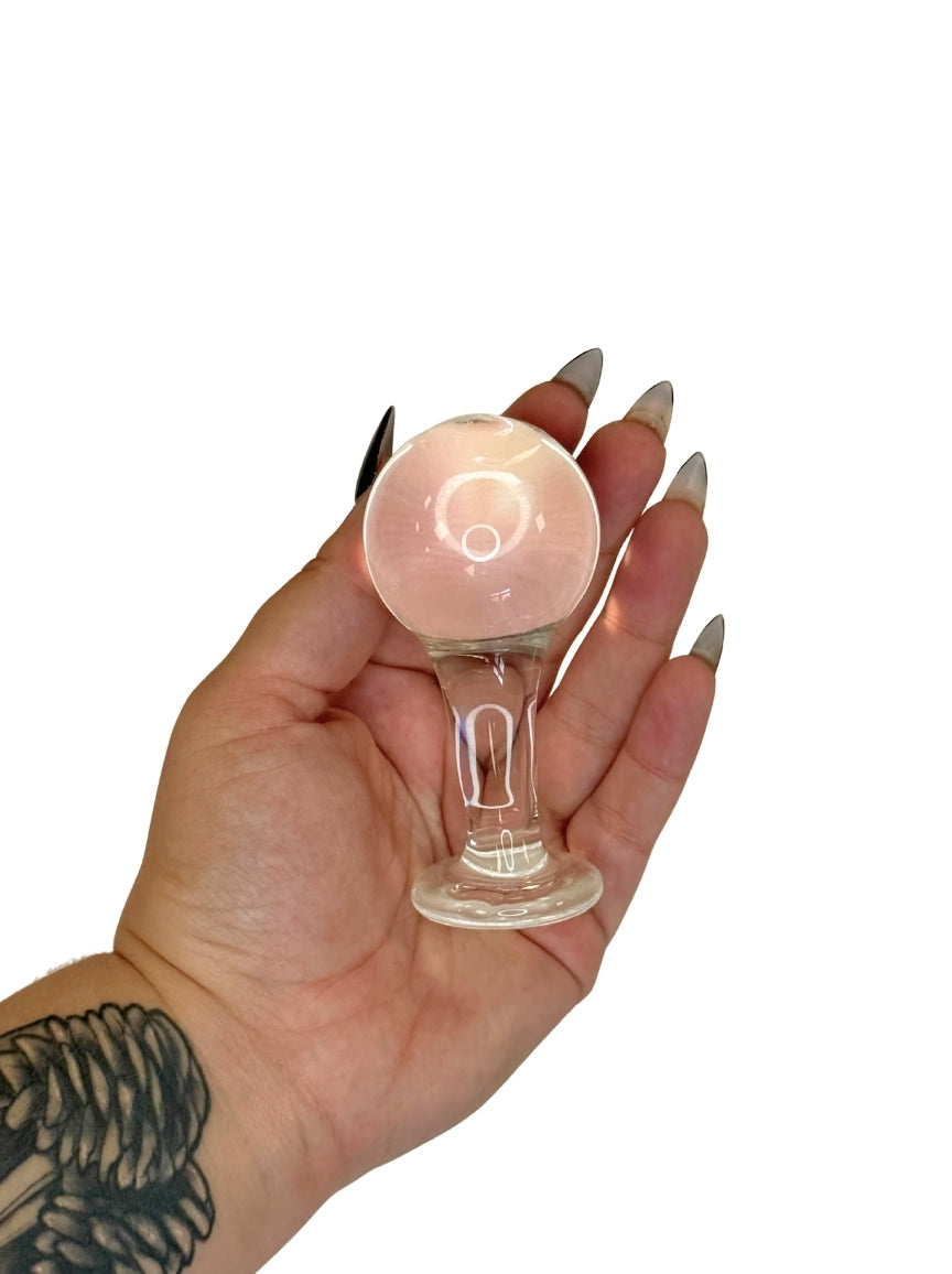 Hand holding a small glass Butt Plug  