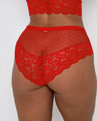 Close-up back view of Eva chilli red briefs by Tutti Rouge, featuring sheer dotted mesh, floral lace panels and a flattering fuller-coverage fit for curvy figures.