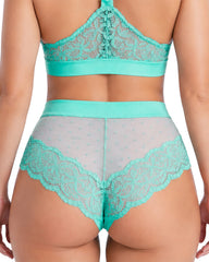 Back view of a model wearing the Tutti Rouge Francine Thong in Ocean Wave, featuring a flattering high-waisted silhouette, sheer dotted mesh back and delicate floral lace trim.