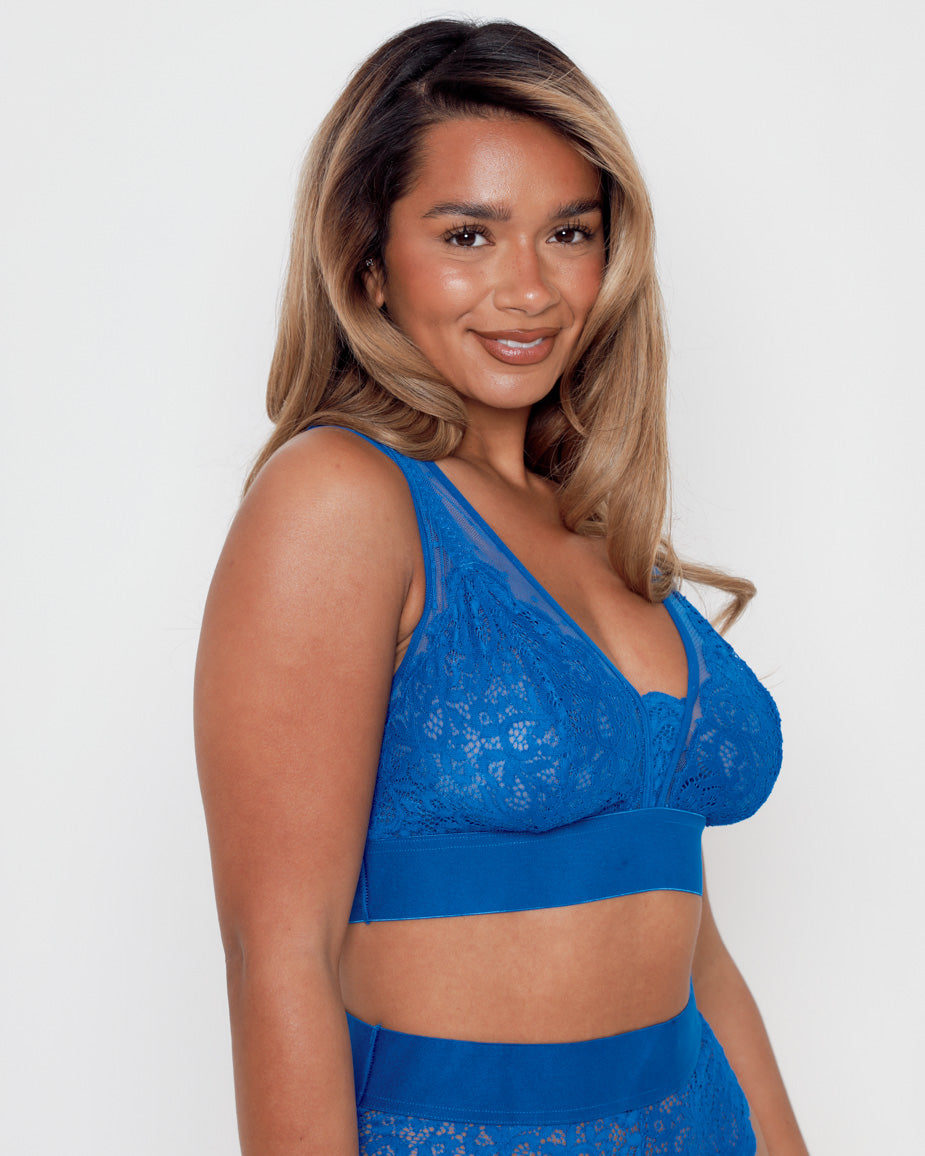 Side profile of a model wearing the Hallie Bra and Brief Set in Dazzling Blue by Tutti Rouge, highlighting the soft stretch lace construction and comfortable, curve-enhancing fit.