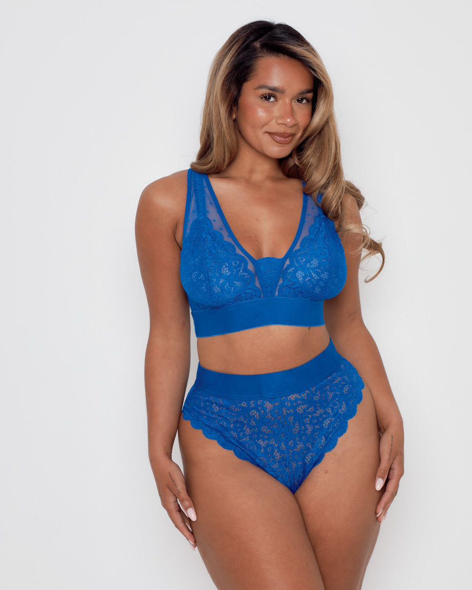Model wearing the Hallie Bra and Brief Set in Dazzling Blue by Tutti Rouge, featuring soft floral lace, sheer mesh panels, a deep V-neckline, and high-waisted briefs for a flattering everyday fit.