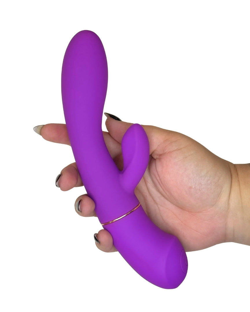 Purple toy held in a hand against a white background