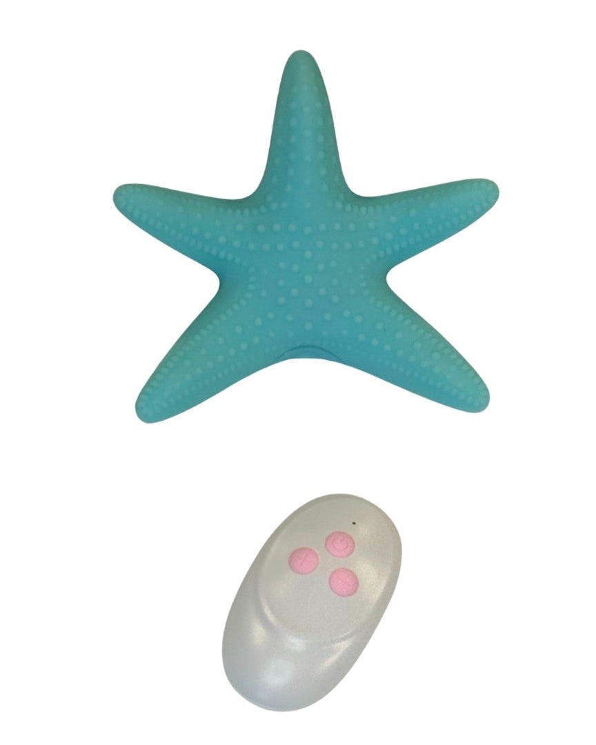 Turquoise starfish-shaped object with a remote control on a white background