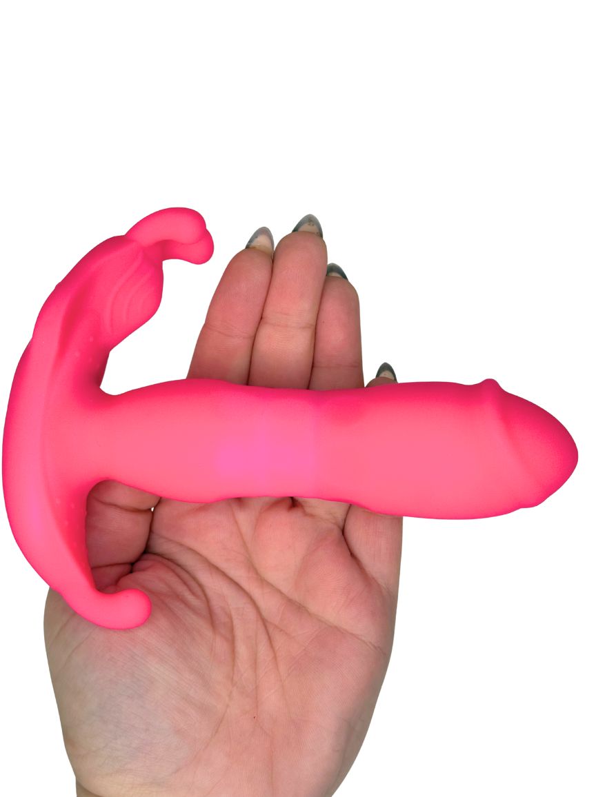Hand holding a pink silicone product against a white background