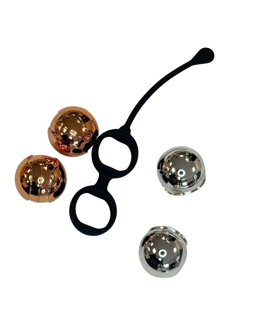 Kegal Balls displaying the 4 weights and the black silicone holder from brand x 
