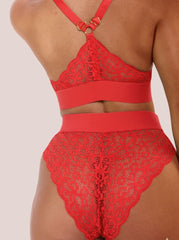 Red lace lingerie set on a neutral background